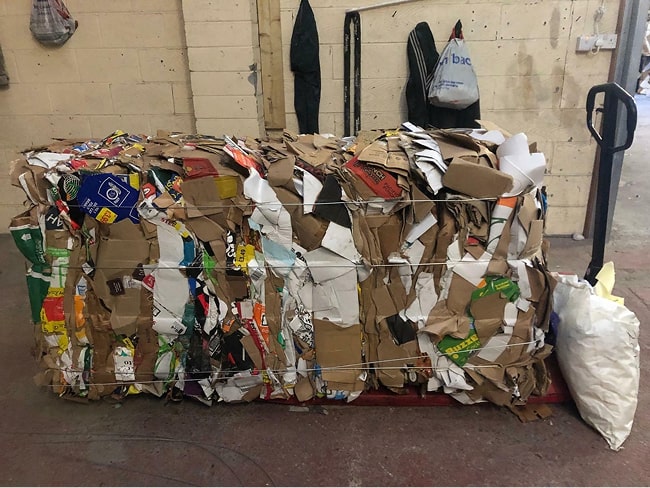  several cardboard bales produced by the Kenburn horizontal baling machine.