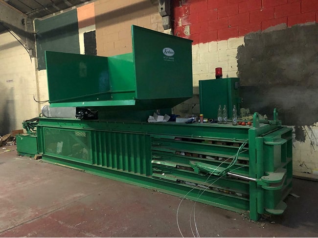 Close up of the horizontal cardboard baling machine installed at Bristol Waste by Kenburn engineers