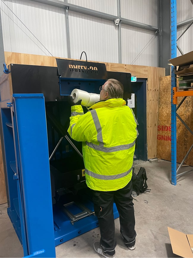 engineer installing a 30 Balex baling machine in a Staffordshire brewery